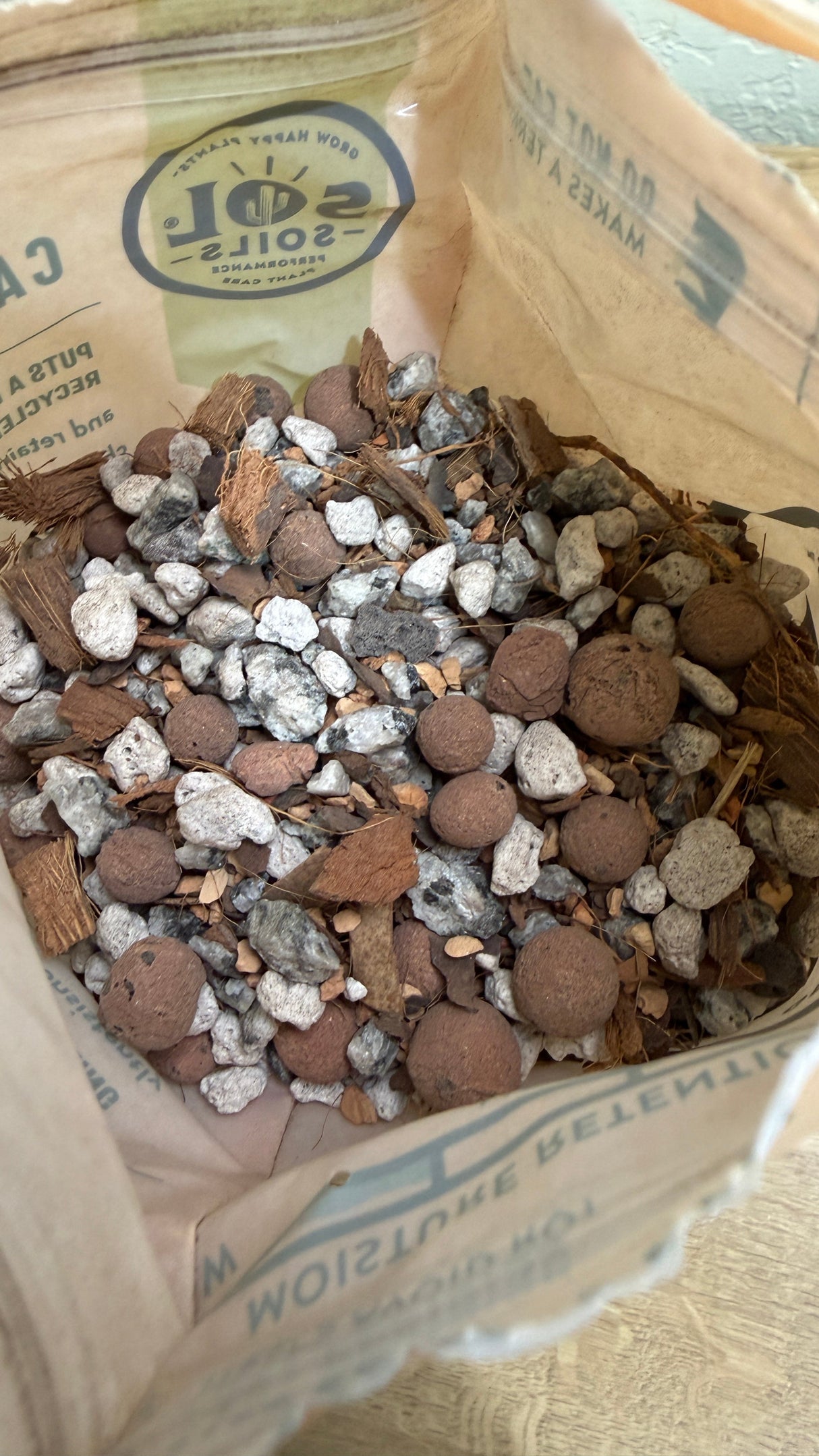 Open bag of cactus gritty mix showing pumice, granite, calcined clay and coconut husk chips