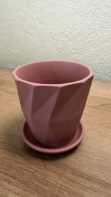 Pink ceramic planter seen from above showing the smooth interior and matching saucer